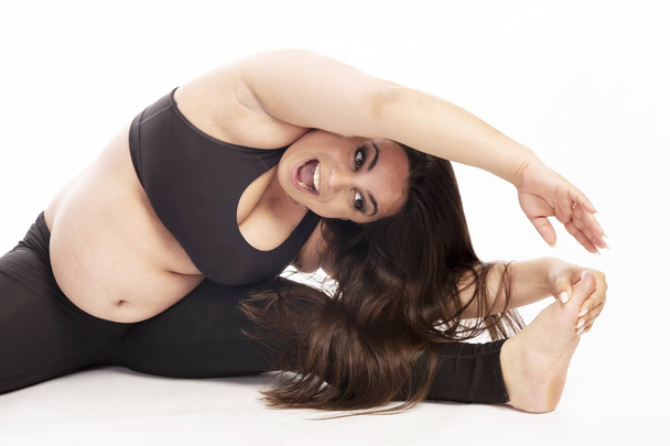 Young fat woman doing aerobic exercise, white background - Fotó, kép