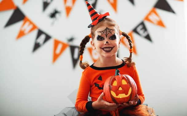happy laughing child girl in pumpkin costume to hallowee - Photo, Image