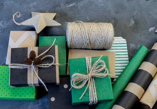 Packing of new kraft paper of the New Year and Christmas gift, green and black. Material for decorating the holiday. Natural decor in the style of eco-style. - Photo, image