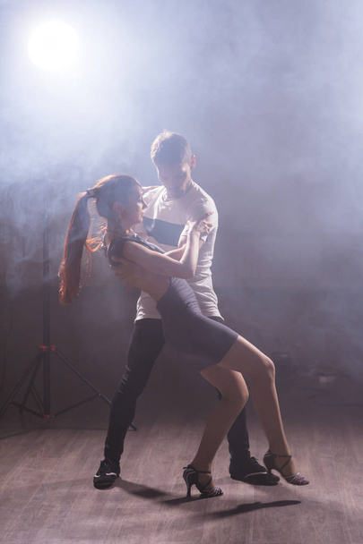 Active happy adults dancing bachata together in dance class - Photo, image