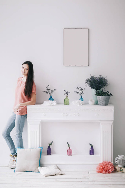 beautiful young woman standing in stylish decorated living room - 写真・画像