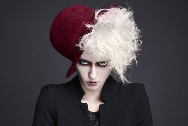 fashion portrait of halloween make-up woman in hat.white skin and hair fairy girl - Foto, imagen