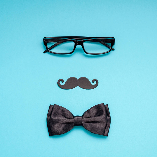 Creative square flatlay overhead top view retro black paper photo booth props moustaches turquoise background copy space. Men health awareness month fathers day masculinity concept blog social media - Photo, Image