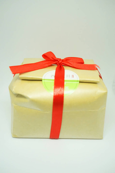Gift from kraft paper with a red ribbon - Photo, Image
