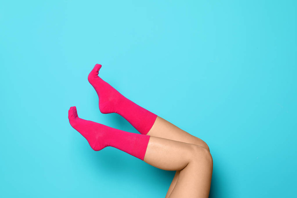 Woman wearing bright socks on color background - 写真・画像