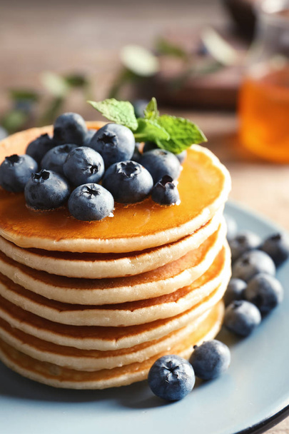 Plate with pancakes and berries on table, closeup - Photo, Image