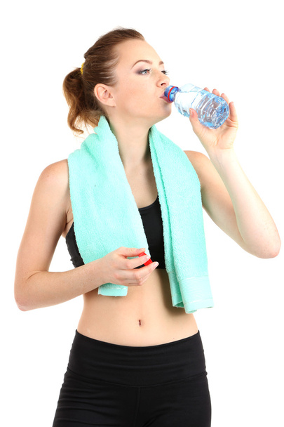 Young woman with water after workout isolated on white - Фото, изображение