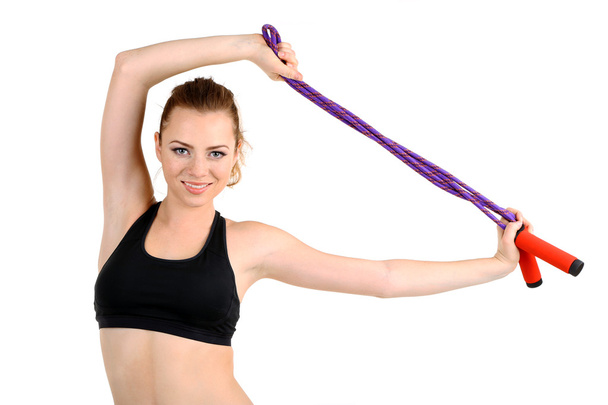 Young woman with skipping rope isolated on white - Foto, Imagen