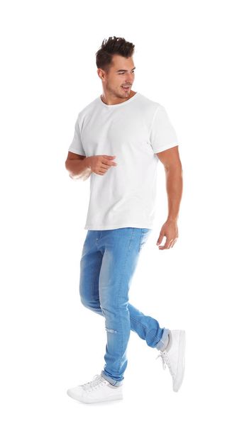 Young man in stylish jeans on white background - Foto, afbeelding