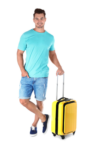 Young man with suitcase on white background - Valokuva, kuva