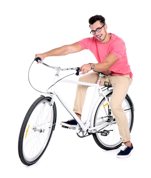 Handsome young hipster man with bicycle on white background - Фото, изображение