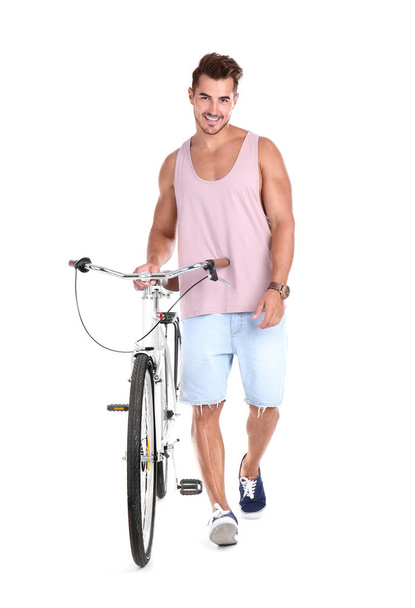 Handsome young hipster man with bicycle on white background - Zdjęcie, obraz