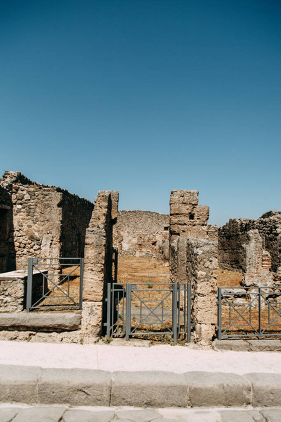 Destroyed ancient ruins of Pompeii. historical ruins with views on mount Vesuvius, Italy. Fossils and excavations, panoramic view of the city. Attractions and world heritage. - Photo, image