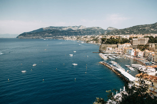 Views of the city of Sorrento in Italy, panorama and top view. Night and day, the streets and the coast. Beautiful landscape and brick roofs. Architecture and monuments of antiquity. Shops and streets with fountains and sculptures. - 写真・画像