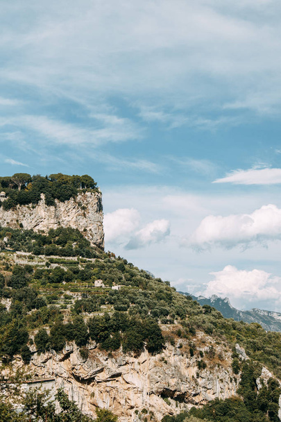 The Amalfi coast and the mountain slopes with plantations of lemons. Panoramic view of the city and nature of Italy. Evening landscapes and winding roads. Sky over the sea and rocks. - 写真・画像