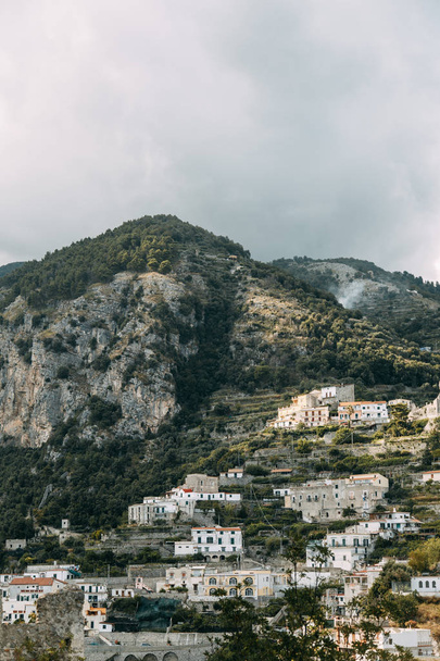 The Amalfi coast and the mountain slopes with plantations of lemons. Panoramic view of the city and nature of Italy. Evening landscapes and winding roads. Sky over the sea and rocks. - Φωτογραφία, εικόνα
