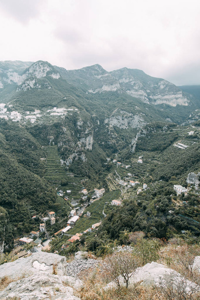 The Amalfi coast and the mountain slopes with plantations of lemons. Panoramic view of the city and nature of Italy. Evening landscapes and winding roads. Sky over the sea and rocks. - 写真・画像