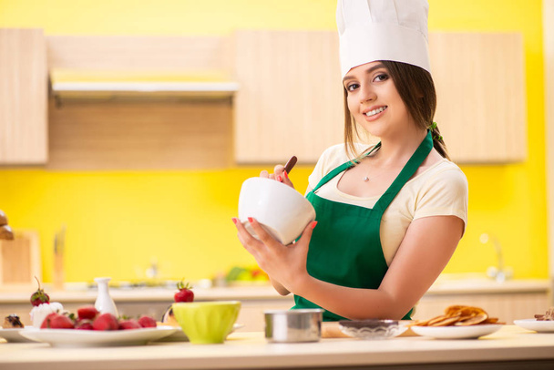Young woman preparing salad at home in kitchen - Photo, Image