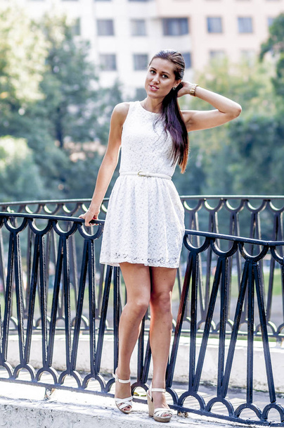 Young girl in white dress in summer park on the bridge - Photo, Image