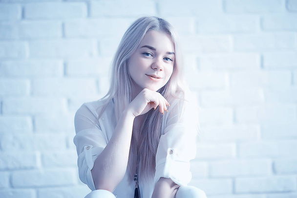 beauty portrait of cute blonde young woman in white clothes - Фото, зображення