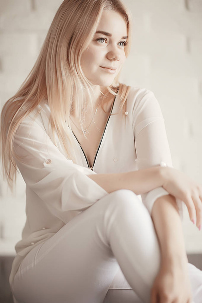 beauty portrait of cute blonde young woman in white clothes - 写真・画像