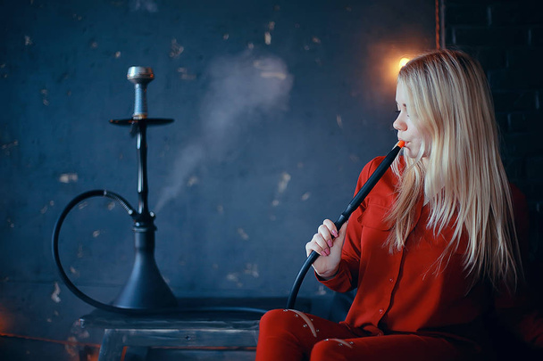 attractive young blonde woman in red clothes smoking hookah - Fotoğraf, Görsel