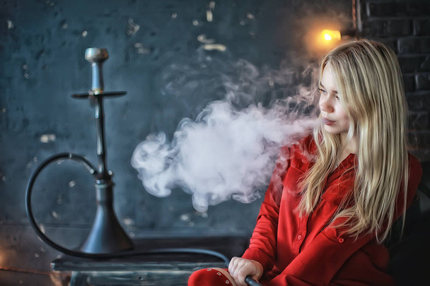 attractive young blonde woman in red clothes smoking hookah - Foto, immagini