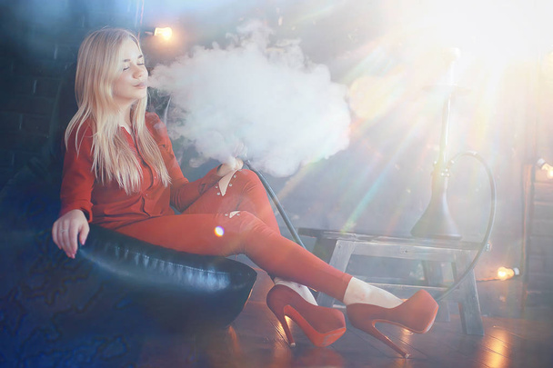 attractive young blonde woman in red clothes smoking hookah - Φωτογραφία, εικόνα