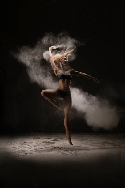 Slim woman dancing in white powder cloud - Foto, Imagen