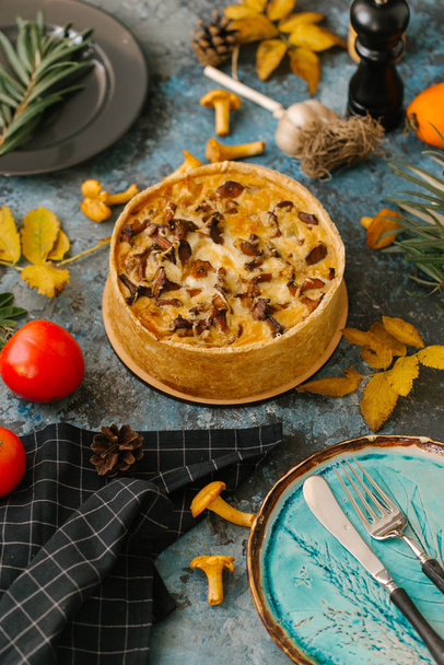fresh quiche with wild mushrooms served with autumn leaves on stone background - Fotoğraf, Görsel