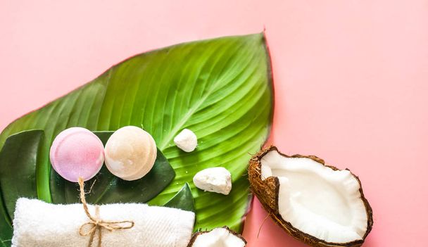 Beautiful Spa composition with the coconut on a pink background, the concept of beauty and health - Фото, изображение