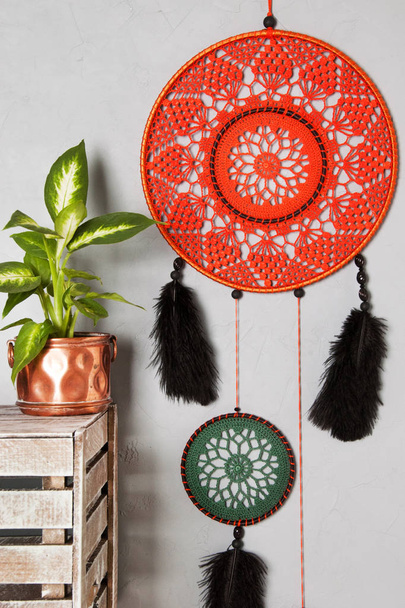 Orange dream catcher in bedroom interior on gray textured background. Bedroom decor and copy space for text - Photo, Image