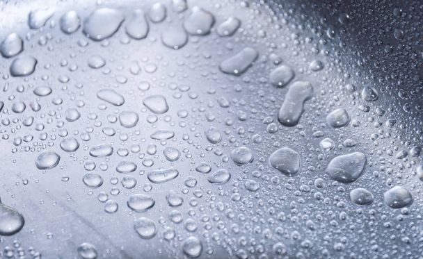 Water drops on metal surface. Macro with shallow depth of field. - Foto, Imagem