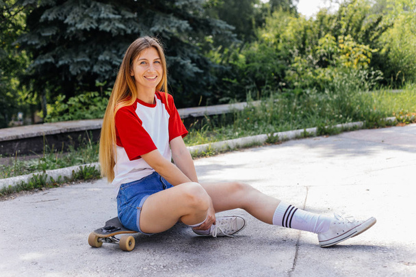 Beautiful skater woman riding on her longboard in the city - Foto, imagen