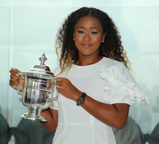 NEW YORK - SEPTEMBER 8, 2018: 2018 US Open champion Naomi Osaka of Japan poses with US Open trophy on the Top of the Rock Observation Deck at Rockefeller Center in New York - 写真・画像
