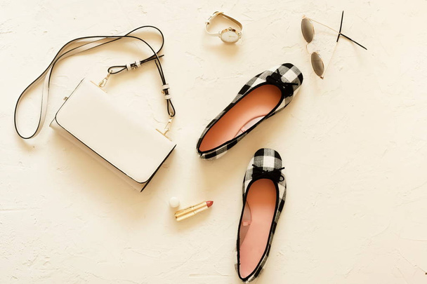 Flat lay, top view of female fashion accessories.White handbag, sunglasses,  shoes ballerina and cosmetics on white vintage background. Copy space - Photo, image