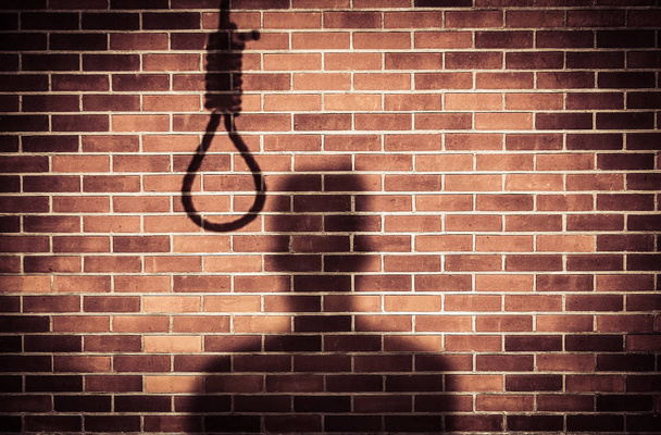 shadow of a sad man with hangman noose on wall while making decision to suicide - Фото, зображення