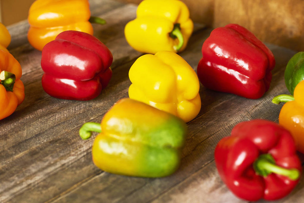 Raw colorful Organic Bell Peppers on wooden background - Photo, Image