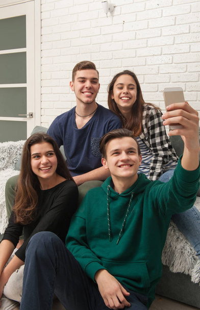 A company of teenagers makes selfies - Фото, изображение