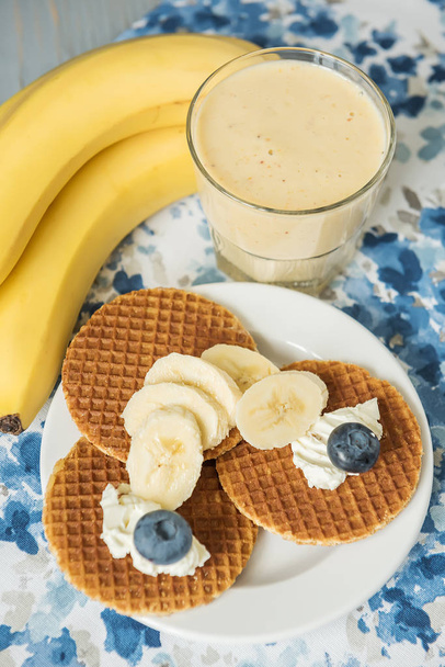 Banana frash, waffles with soft cheese and many different berries. Useful tasty breakfast, snack. - Foto, afbeelding