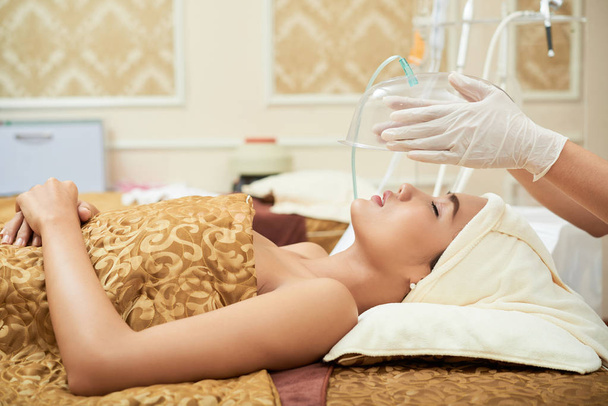 woman having facial treatment at modern spa salon - Photo, Image