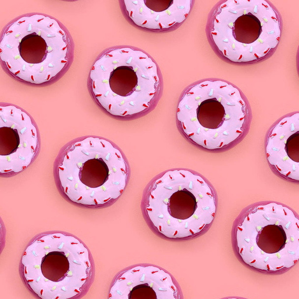 Many small plastic donuts lies on a pastel colorful background. Flat lay minimal pattern. Top view - Photo, Image