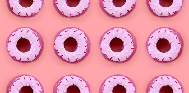 Birçok küçük plastik donuts bir pastel renkli arka plan üzerinde yatıyor. Düz yatıyordu en az desen. Üstten görünüm - Fotoğraf, Görsel