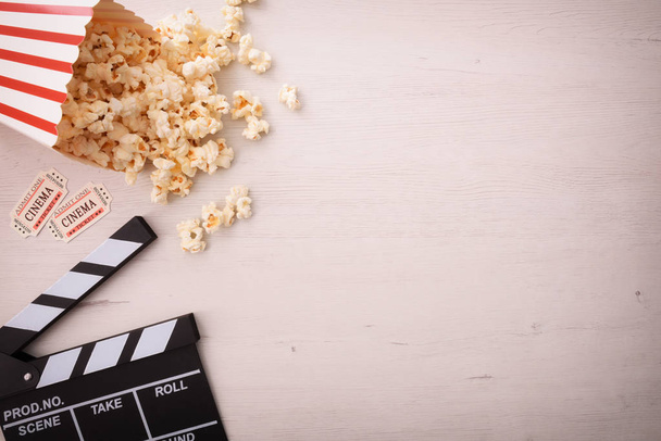 Background of watching movies with several objects with a wooden background. Horizontal composition. Top view. - Photo, image