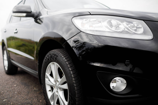 Black modern car closeup. Black modern car headlights - front vi - Foto, imagen
