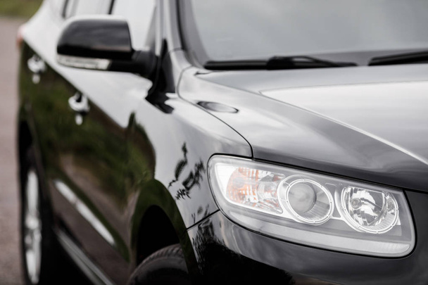 Black modern car closeup. Black modern car headlights - front vi - Foto, Imagen