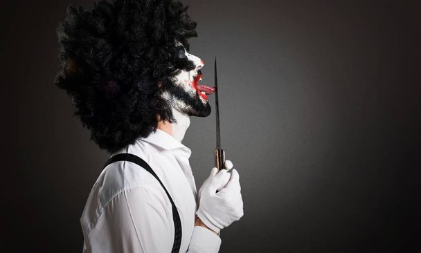 Killer clown with knife on textured background - Fotografie, Obrázek