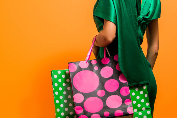 Happy shopping woman holding shopping bags over bright background - 写真・画像