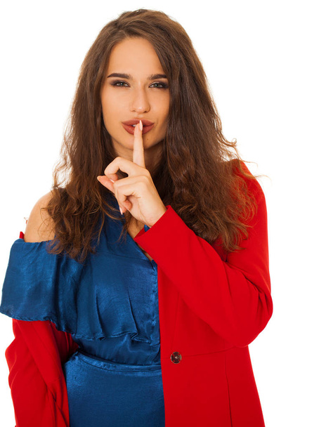 Young beautiful brunette woman has put forefinger to lips as sign of silence, isolated on white background - Foto, Imagen