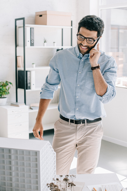 handsome smiling architect talking by smartphone in office - Photo, Image